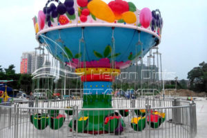 Beautiful Fun Fair Amusement Flying Chair Rides at Night in the Exhibition Hall of Dinis